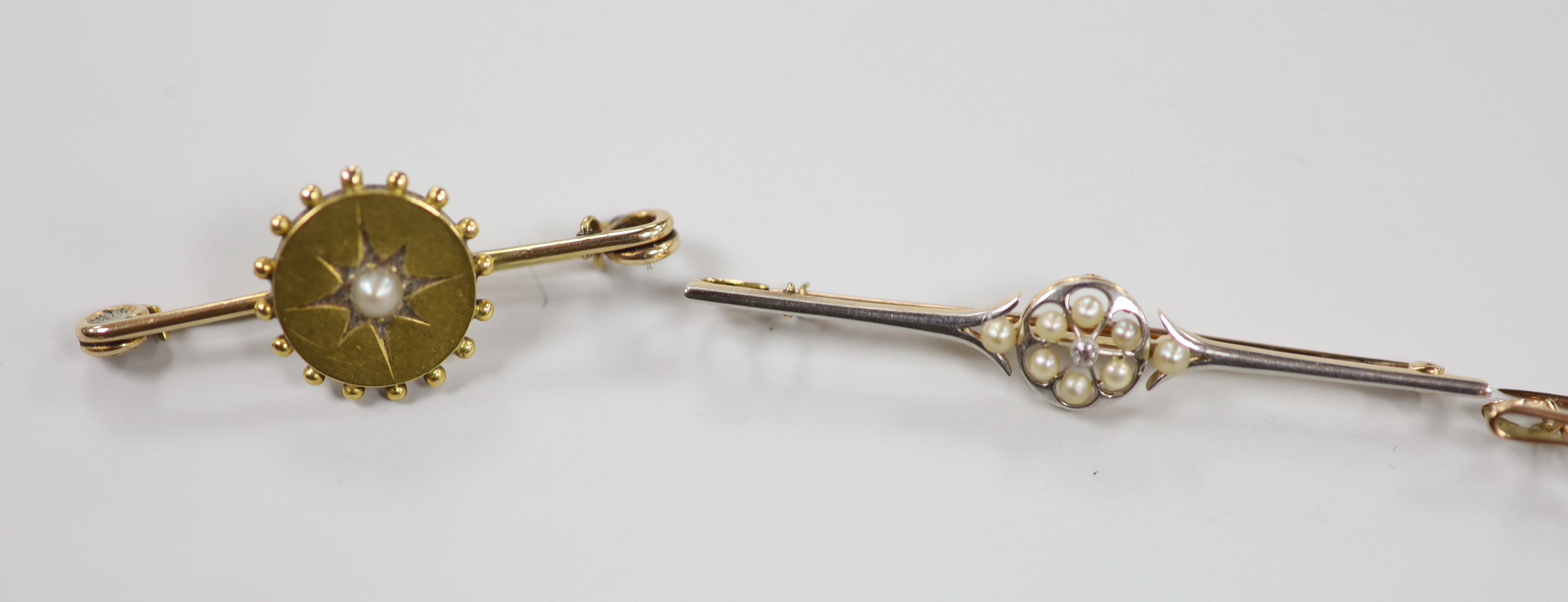 A Victorian 15ct, diamond and seed pearl cluster set bar brooch, 59mm, gross 4 grams and three other early 20th century gem set bar brooches including two 9ct, gross weight 8.7 grams.